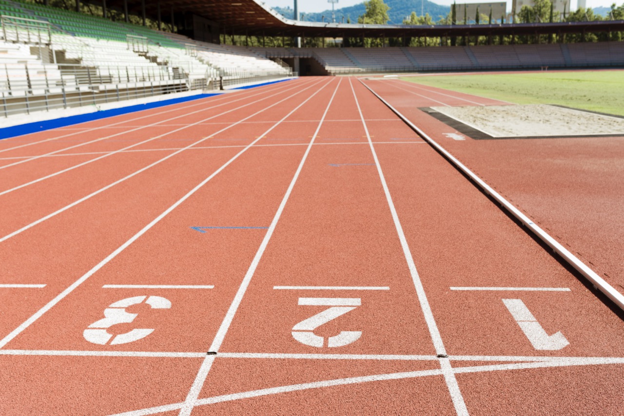 A race track starting line in a professional track and field stadium.