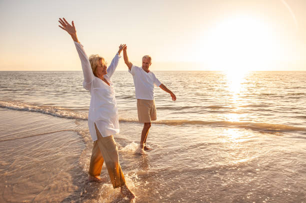 Elderly couple walking on the beach